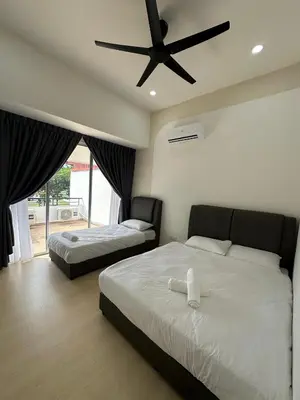 a bedroom with two beds and a ceiling fan at 3Story Family Suites 7pax Ikea Batu Kawan 5min in Batu Kawan