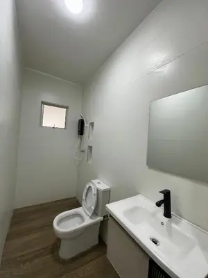 a bathroom with a toilet and a sink and a mirror at 3Story Family Suites 7pax Ikea Batu Kawan 5min in Batu Kawan