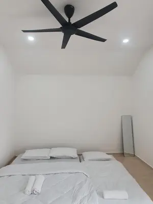 a bedroom with a bed with a black ceiling fan at 3Story Family Suites 7pax Ikea Batu Kawan 5min in Batu Kawan