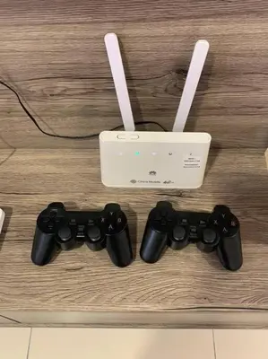 two video game controllers and a box on a table at Veneto Ipoh homestay 3BR with infinity pool in Ipoh