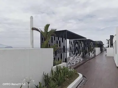 a balcony of a house with chairs and a fence at Veneto Ipoh homestay 3BR with infinity pool in Ipoh