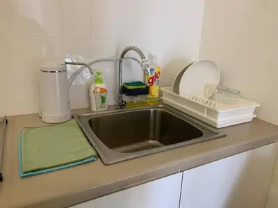 a kitchen counter with a sink in a kitchen at Veneto Ipoh homestay 3BR with infinity pool in Ipoh