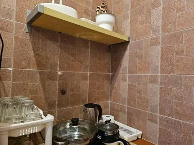 a kitchen counter with a stove with pots and pans at HOME Penang in George Town