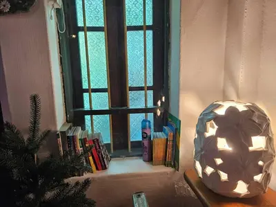 a window with a christmas tree and books in front of it at HOME Penang in George Town