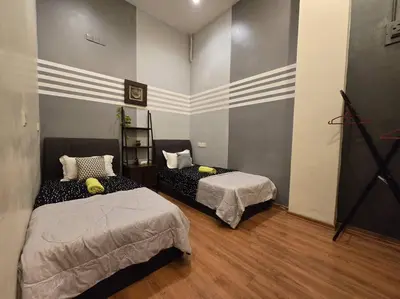 a room with two beds in a room at HOME Penang in George Town