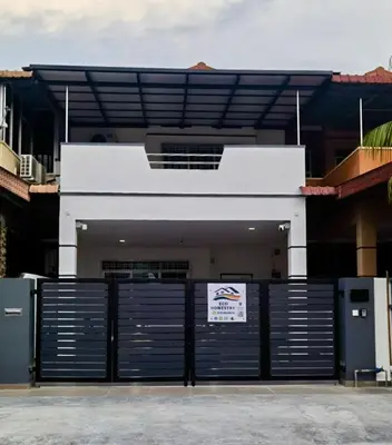 a building with a gate with a sign on it at Eco Homestay in Teluk Intan