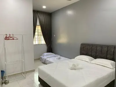 a bedroom with a bed with two towels on it at Eco Homestay in Teluk Intan