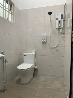 a bathroom with a toilet and a shower at Eco Homestay in Teluk Intan