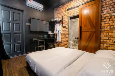 a bedroom with a bed and a brick wall at Ipoh The Label by Verve in Kampong Simee