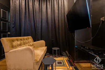 a living room with a chair and a television at Ipoh The Label by Verve in Kampong Simee