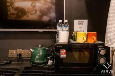 a tea kettle sitting on top of a microwave at Ipoh The Label by Verve in Kampong Simee
