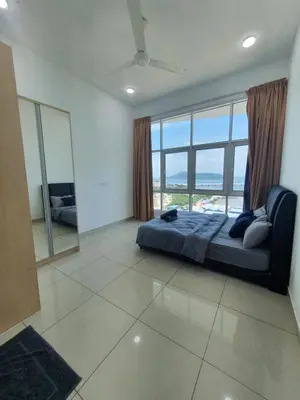 a bedroom with a bed and a large window at Southbay Seaview Condo A2 10minQueensbay 10minSpice in Bayan Lepas