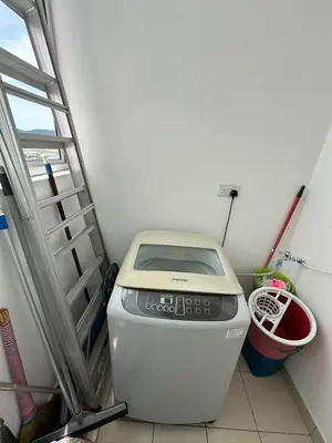 a washing machine in a room with a ladder at Southbay Seaview Condo A2 10minQueensbay 10minSpice in Bayan Lepas