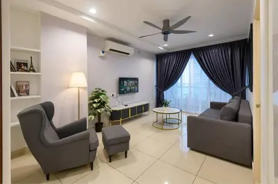 a living room with two chairs and a ceiling fan at 2R2B Seaview Serenity 1 to 8pax Gurney Mansion One in George Town