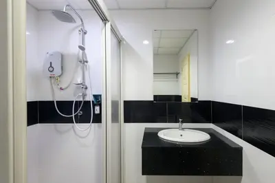 a bathroom with a shower and a sink at 2R2B Seaview Serenity 1 to 8pax Gurney Mansion One in George Town