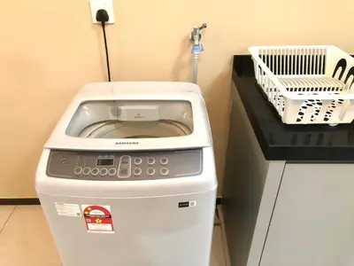 a washing machine sitting on top of a counter at Urban Suite Condominium By Blue Sky Holidays in Jelutong