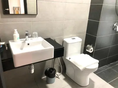 a bathroom with a sink and a toilet at Urban Suite Condominium By Blue Sky Holidays in Jelutong