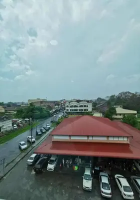 a car dealership with cars parked in a parking lot at Yew Boutique Hotel in Teluk Intan