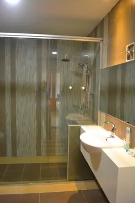 a bathroom with a sink and a shower and a toilet at Yew Boutique Hotel in Teluk Intan