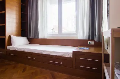a bed in a room with a window at Profolio @ Straits Quay in George Town