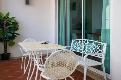 a table and chairs sitting next to a window at Profolio @ Straits Quay in George Town