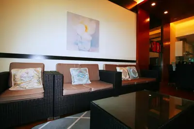 a waiting room with couches and a painting on the wall at Profolio @ Straits Quay in George Town