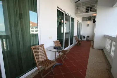 a balcony with chairs and a table and some windows at Profolio @ Straits Quay in George Town