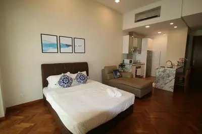 a bedroom with a bed and a couch at Profolio @ Straits Quay in George Town