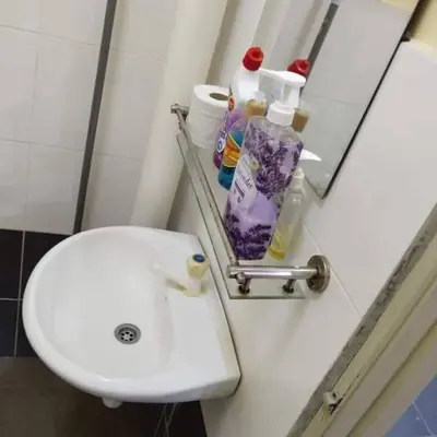 a bathroom with a white sink and a mirror at Happy Raub Guest House in Raub