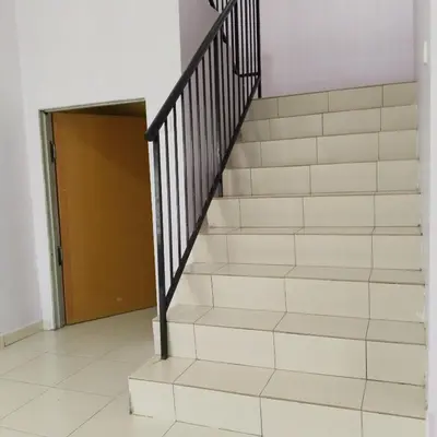 a staircase in a house with a stair case at Happy Raub Guest House in Raub