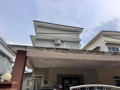 a man standing in front of a house at Happy Raub Guest House in Raub