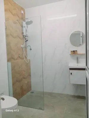 a bathroom with a glass shower with a toilet at Yarra SP Homestay in Sungai Petani