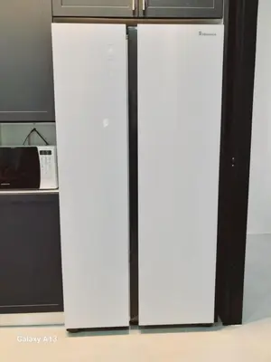 two white refrigerators in a kitchen next to a microwave at Yarra SP Homestay in Sungai Petani