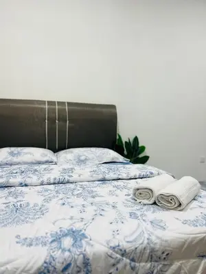 a bed with two towels and two pillows on it at Casa Kita Homestay in Bandar Baharu