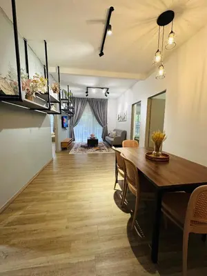 a dining room and living room with a table and chairs at Adamhawa Homestay 3 Emerald Avenue Brinchang in Brinchang