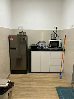 a kitchen with a refrigerator and a microwave at Adamhawa Homestay 3 Emerald Avenue Brinchang in Brinchang