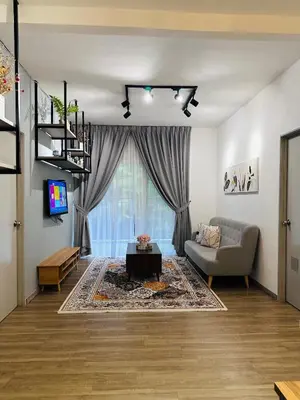 a living room with a couch and a tv at Adamhawa Homestay 3 Emerald Avenue Brinchang in Brinchang