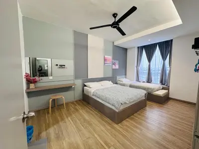 a bedroom with two beds and a ceiling fan at Adamhawa Homestay 3 Emerald Avenue Brinchang in Brinchang