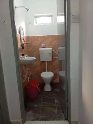 a small bathroom with a toilet and a sink at D'SQ Homestay in Tanjung Karang