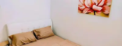 a couch in a room with a painting on the wall at Cozy Homestay in Ipoh
