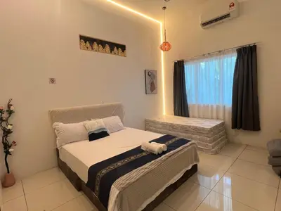 a bedroom with a bed and a window at Legreene Ipoh 15pax in Tambun