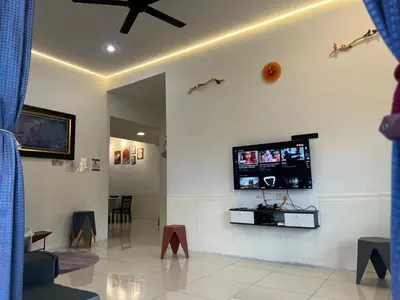 a living room with a flat screen tv on the wall at Legreene Ipoh 15pax in Tambun