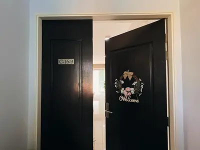 a black door with a wreath on it at Ipoh Lakeside Apartment with Mountain View in Kampong Batu Lapan