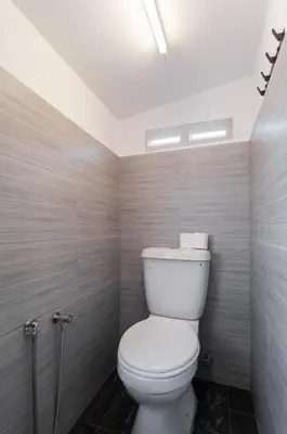 a bathroom with a white toilet in a room at Aayu Seckchuan - 3 mins walk to Love Lane in George Town