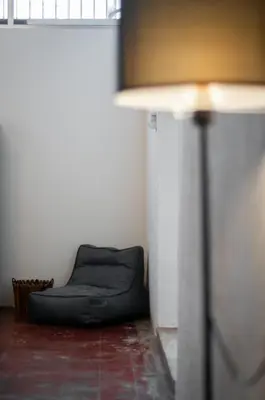 a black bean bag chair in a room with a lamp at Aayu Seckchuan - 3 mins walk to Love Lane in George Town
