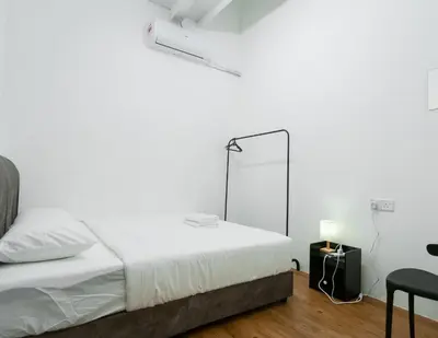 a white bedroom with a bed and a mirror at Aayu Seckchuan - 3 mins walk to Love Lane in George Town