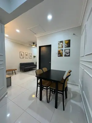 a dining room with a black table and chairs at Namel Homestay Taiping in Kampong Jana