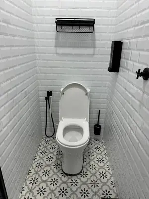 a bathroom with a white toilet in a stall at Namel Homestay Taiping in Kampong Jana