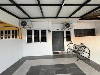 a bench in front of a building with speakers at Namel Homestay Taiping in Kampong Jana