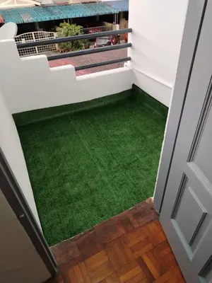 an open door with a green floor in a house at Busybee Breezy Stay Homestay in Ipoh